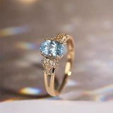 Exclusive gold ring with blue crystal
