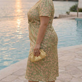 Midi dress with shaping effect, central knot, and fluid drape